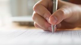 Test-exam-hand-writing-paper-with-pen.jpg